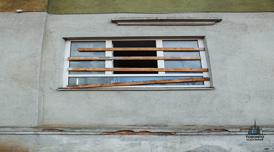 A boarded-up plastic window in an old, abandoned, crumbling building