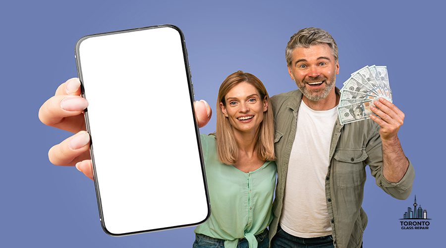 A couple is shown smiling and holding a smartphone with a blank screen and cash in front of a blue background. The woman is holding the smartphone while the man is holding a fan of cash.