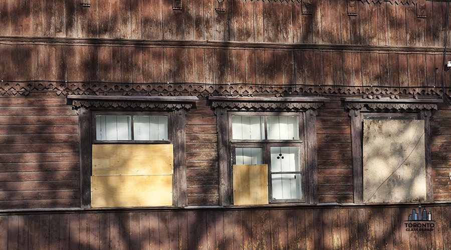 abandoned old wooden house with clogged and closed Windows, part of an old residential building