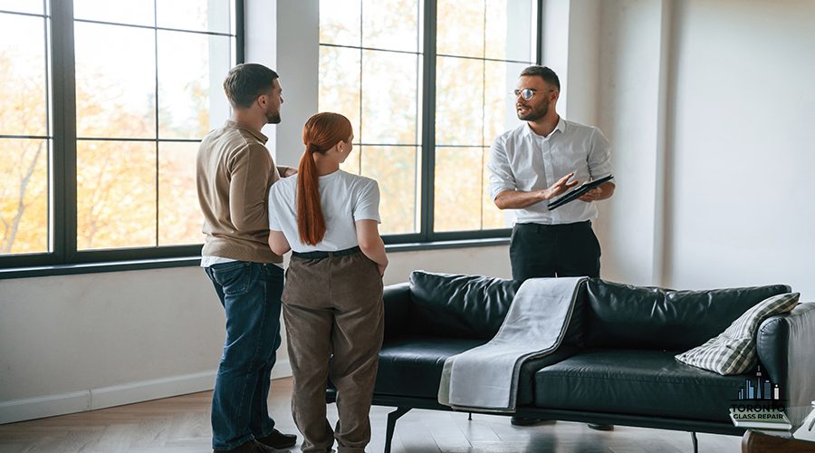 Big windows. Realtor shows an apartment to a young couple.