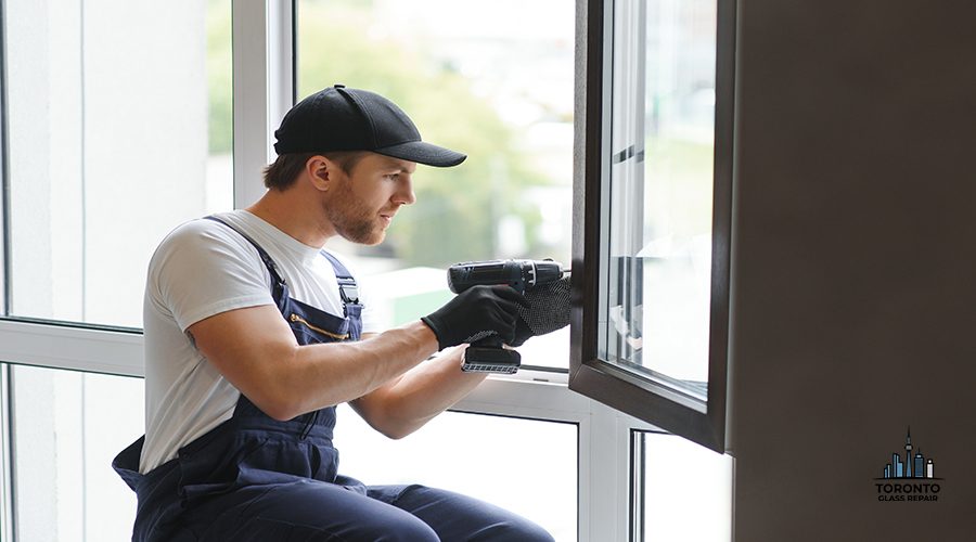 Construction worker installing window in house.