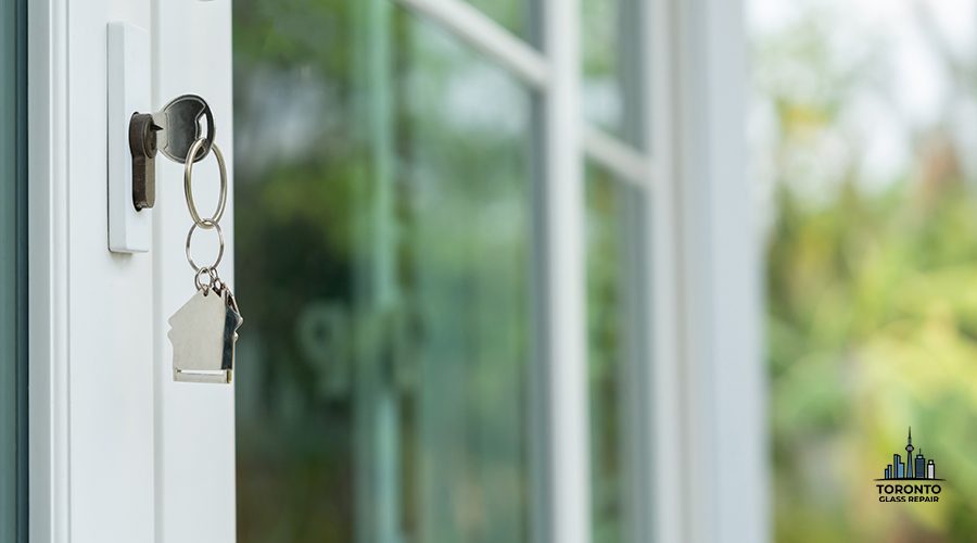 Landlord key for unlocking house is plugged into the door. Second hand house for rent and sale. keychain is blowing in the wind. mortgage for new home, buy, sell, renovate, investment, owner, estate